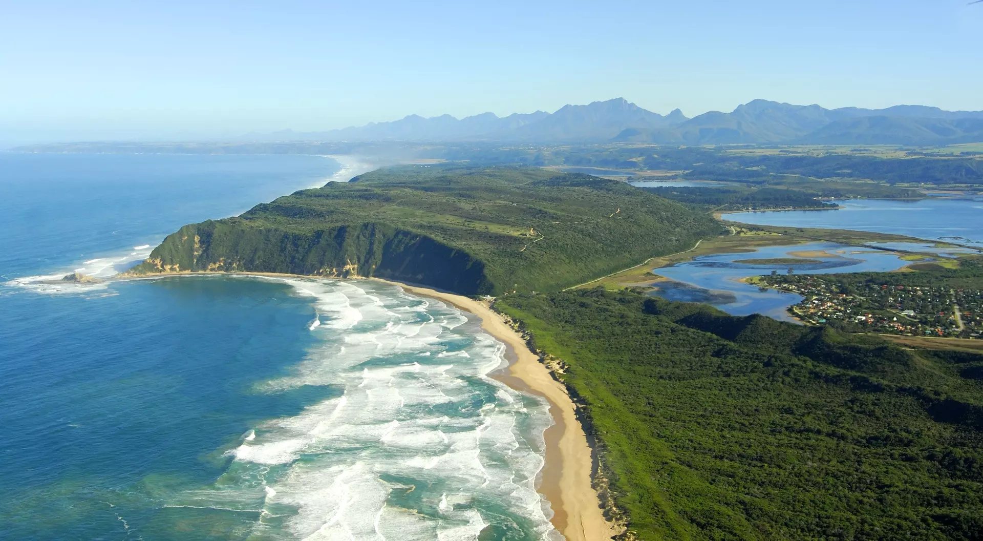 Aerial view of the Garden Route coastline near Knysna Heads with turquoise lagoon
