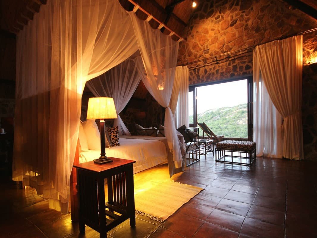A stone-and-thatch room at Big Cave Camp, Matobo
