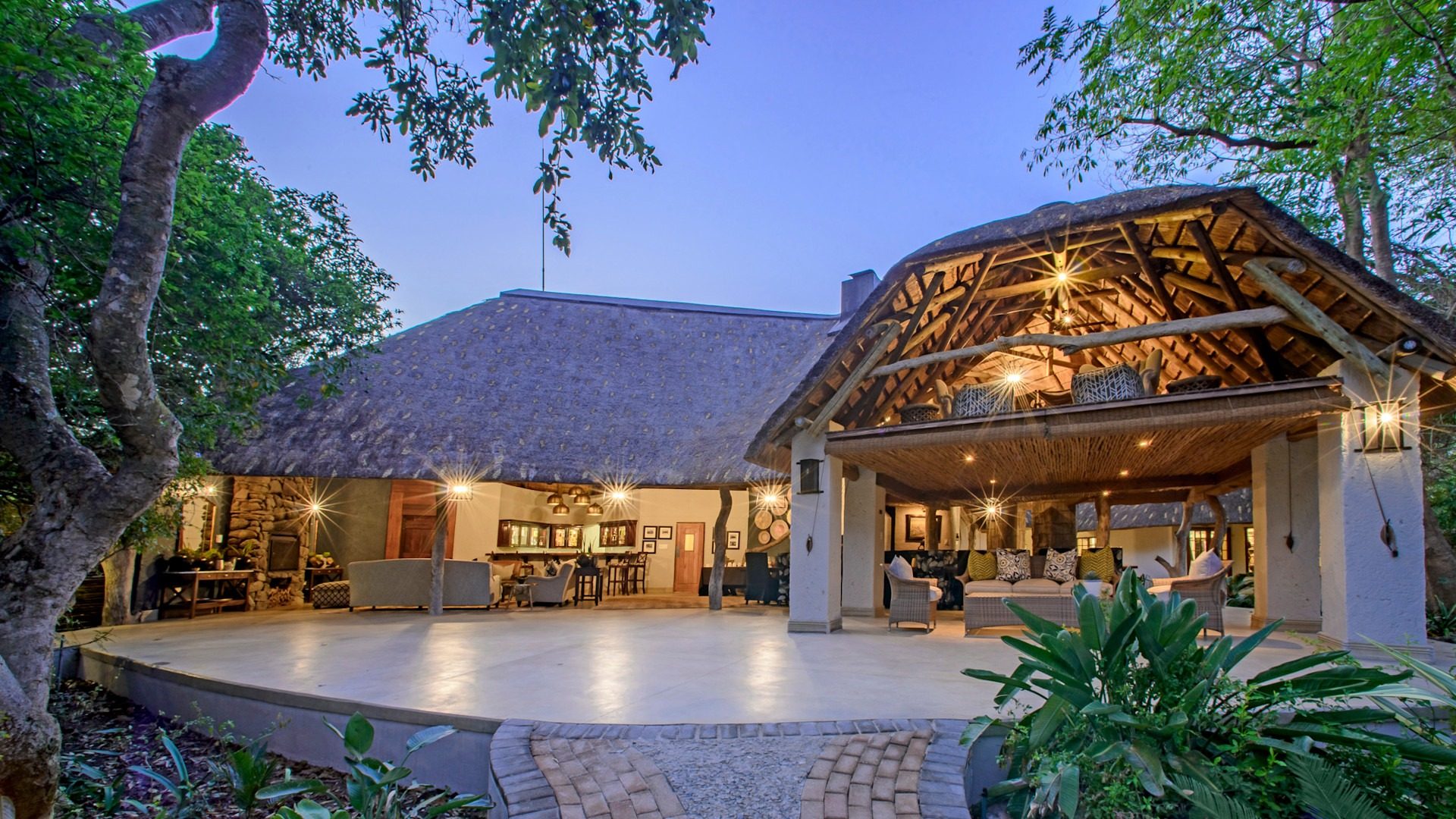 Luxury safari lodge overlooking African bushveld at golden hour — luxury african safari packages