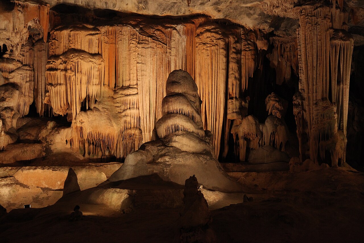 The vast dripstone chambers and ancient limestone formations of the Cango Caves near Oudtshoorn lit in warm amber light