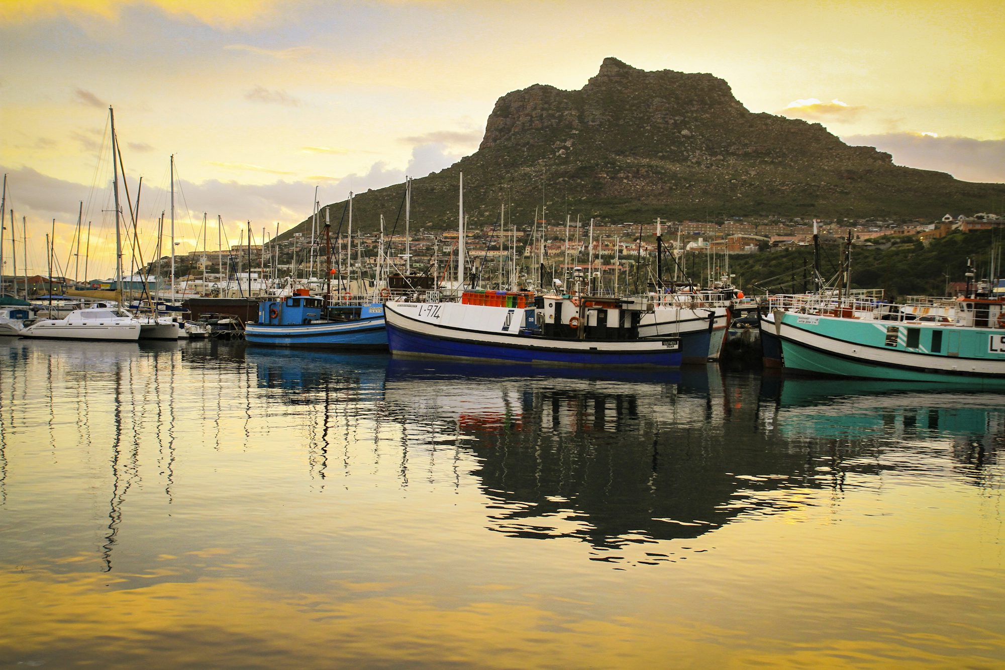 Hout Bay harbour and beach ringed by mountains