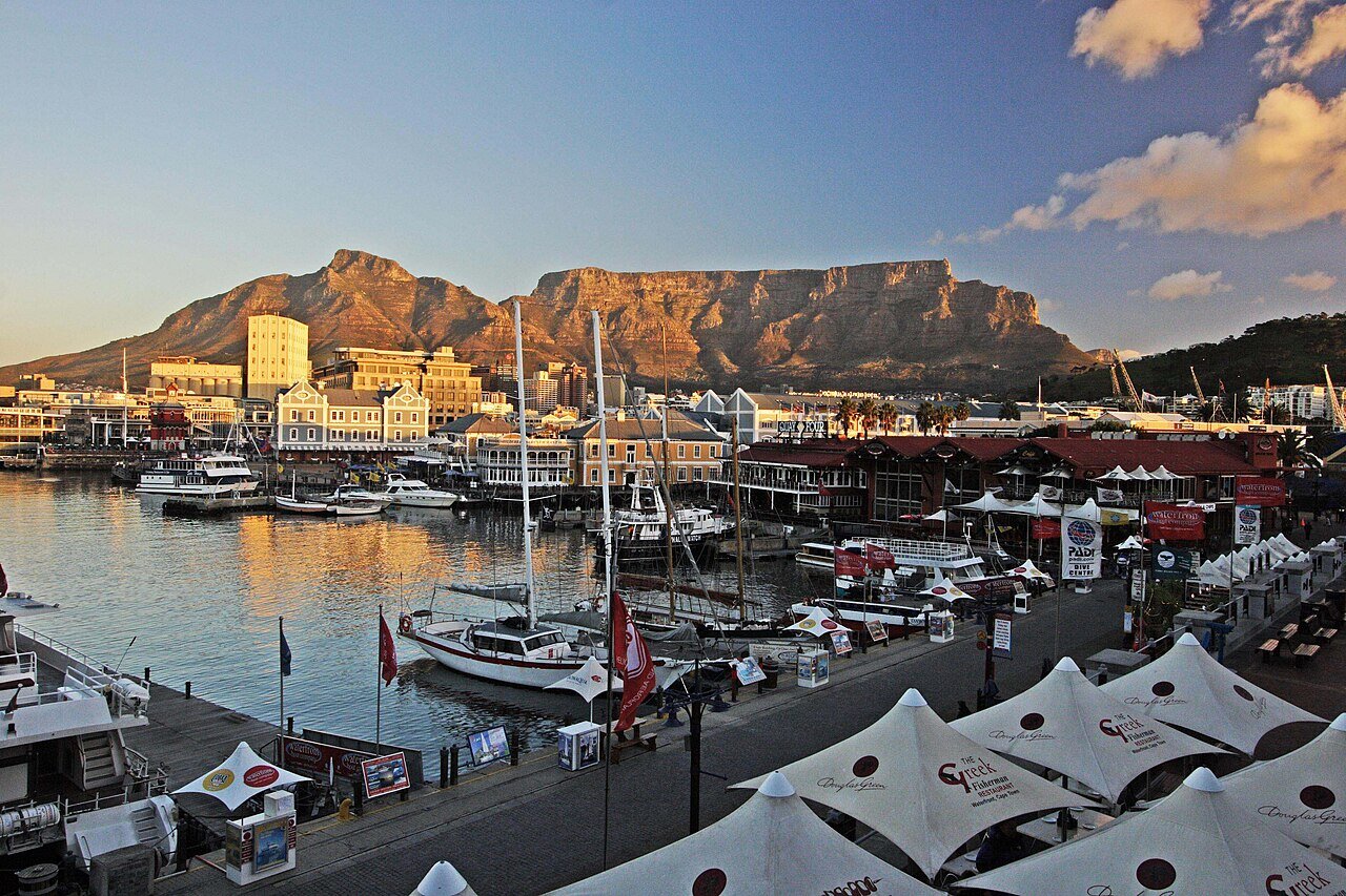 The V&A Waterfront harbour with Table Mountain rising behind Cape Town at golden hour