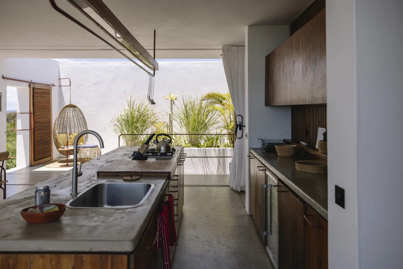 Open kitchen island opening onto a terrace with sea views at Duna Sonâmbula suite, Tofo, Mozambique
