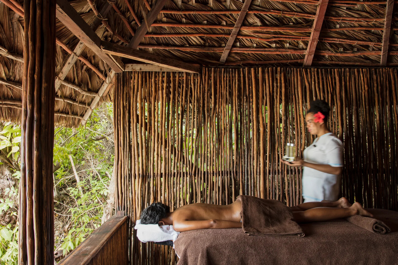 A spa treatment room in natural materials at the water's edge at Constance Tsarabanjina, Madagascar
