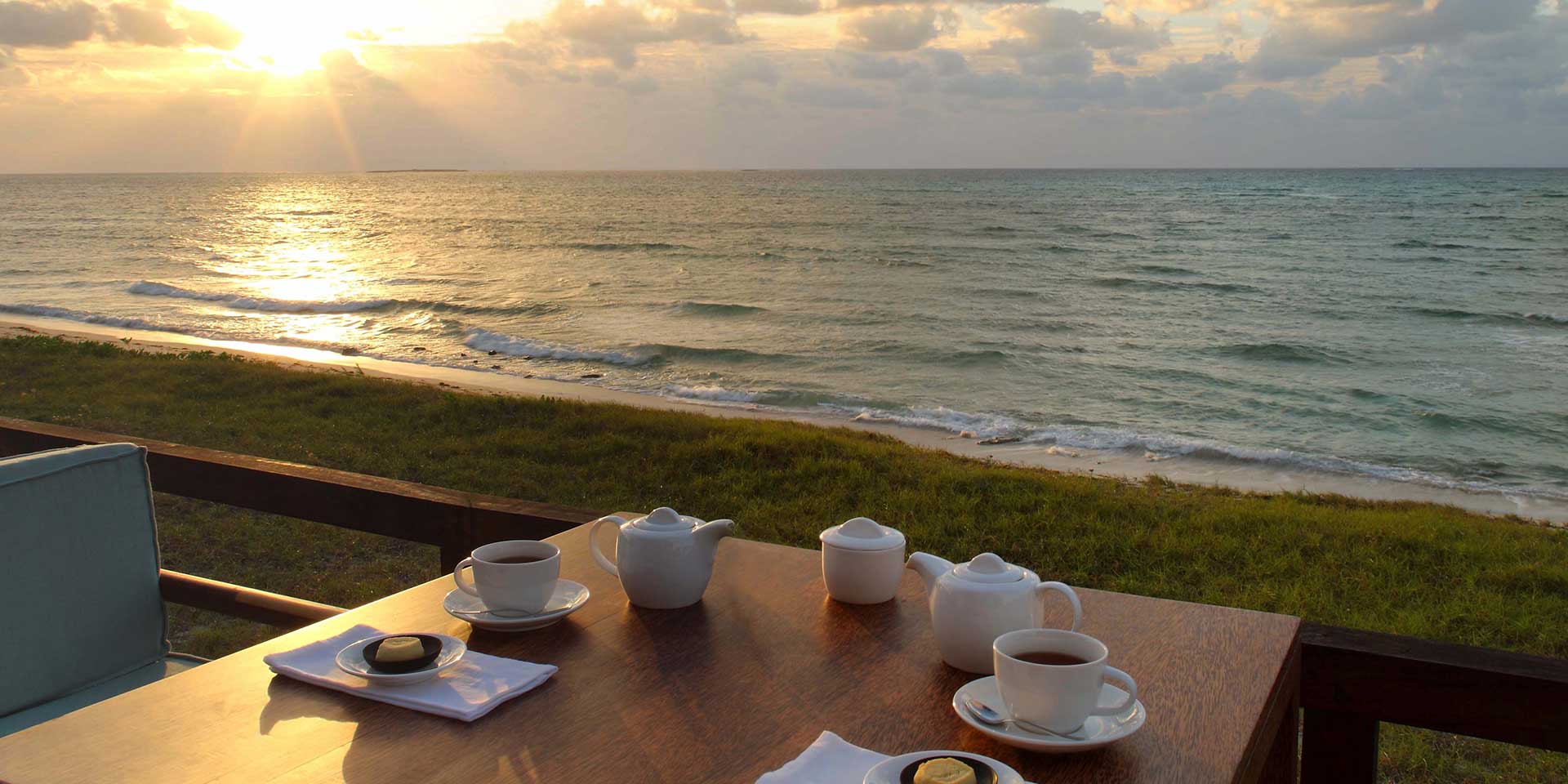 Coral Lodge — beach dining at sunset