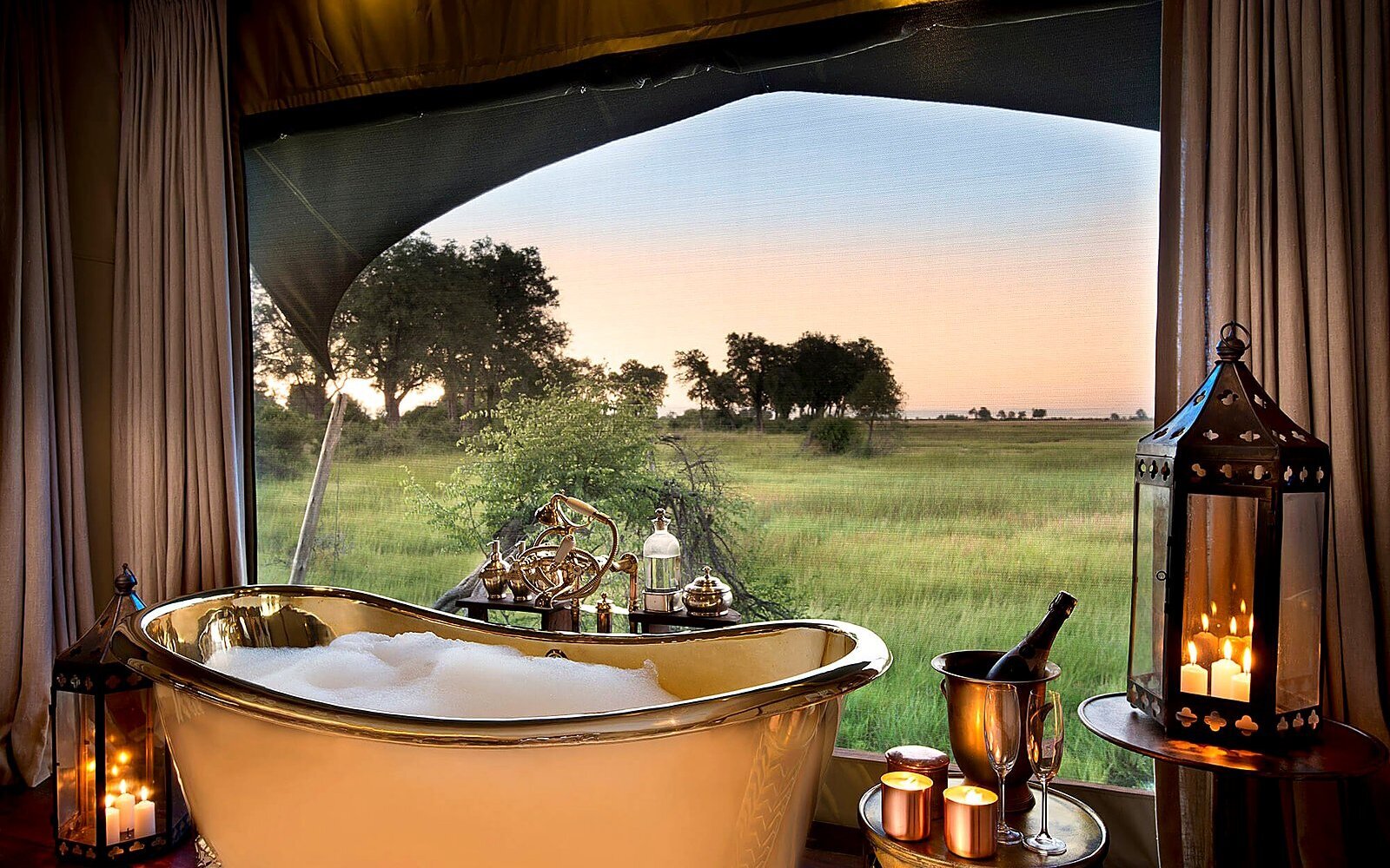 A copper bath in a canvas-and-timber safari suite at Duba Plains in the Okavango Delta