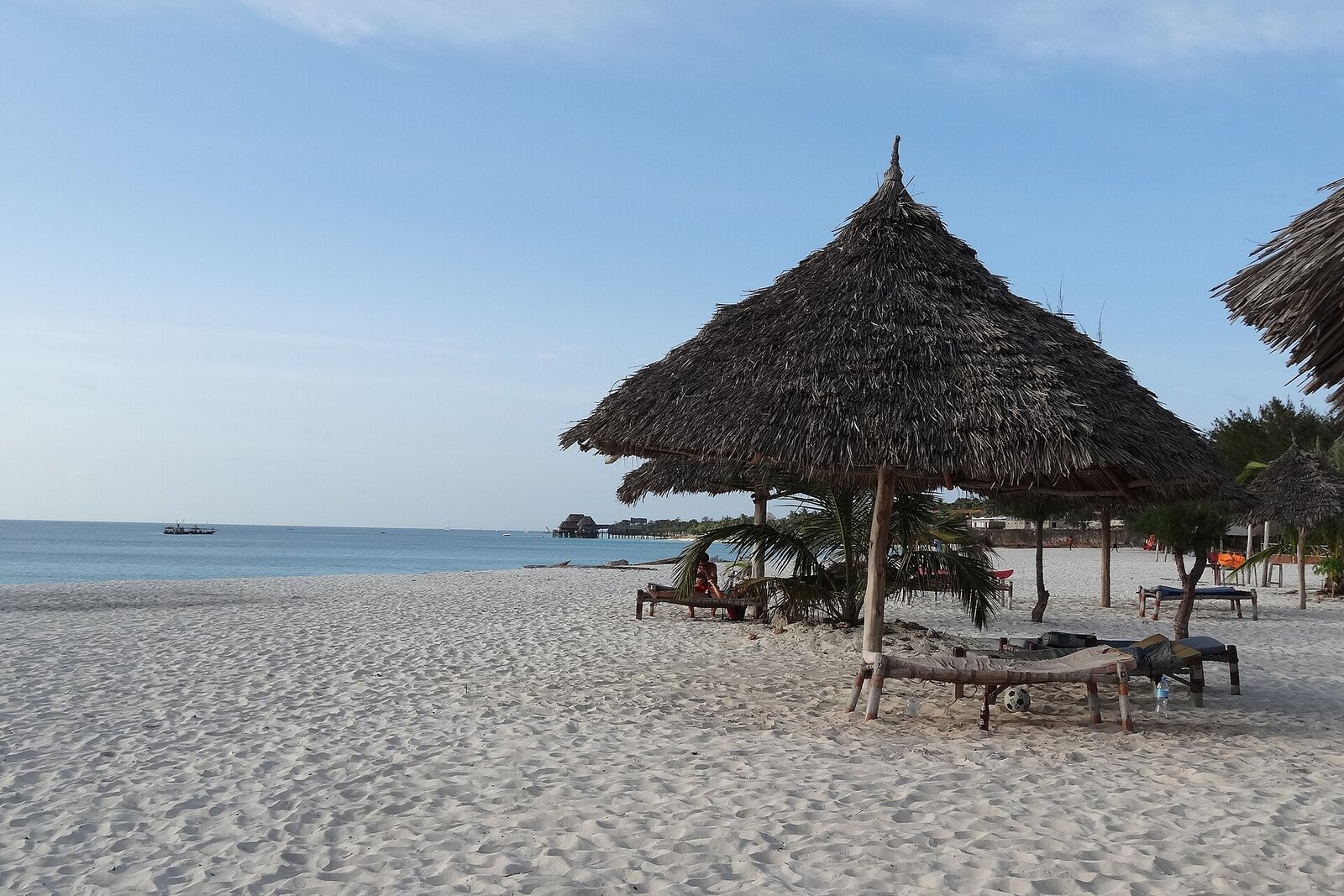 Honeymoon couple walking on a white sand beach in Africa