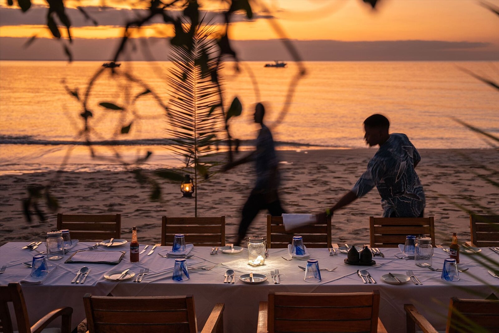 Romantic candlelit beach dinner at sunset on an African honeymoon