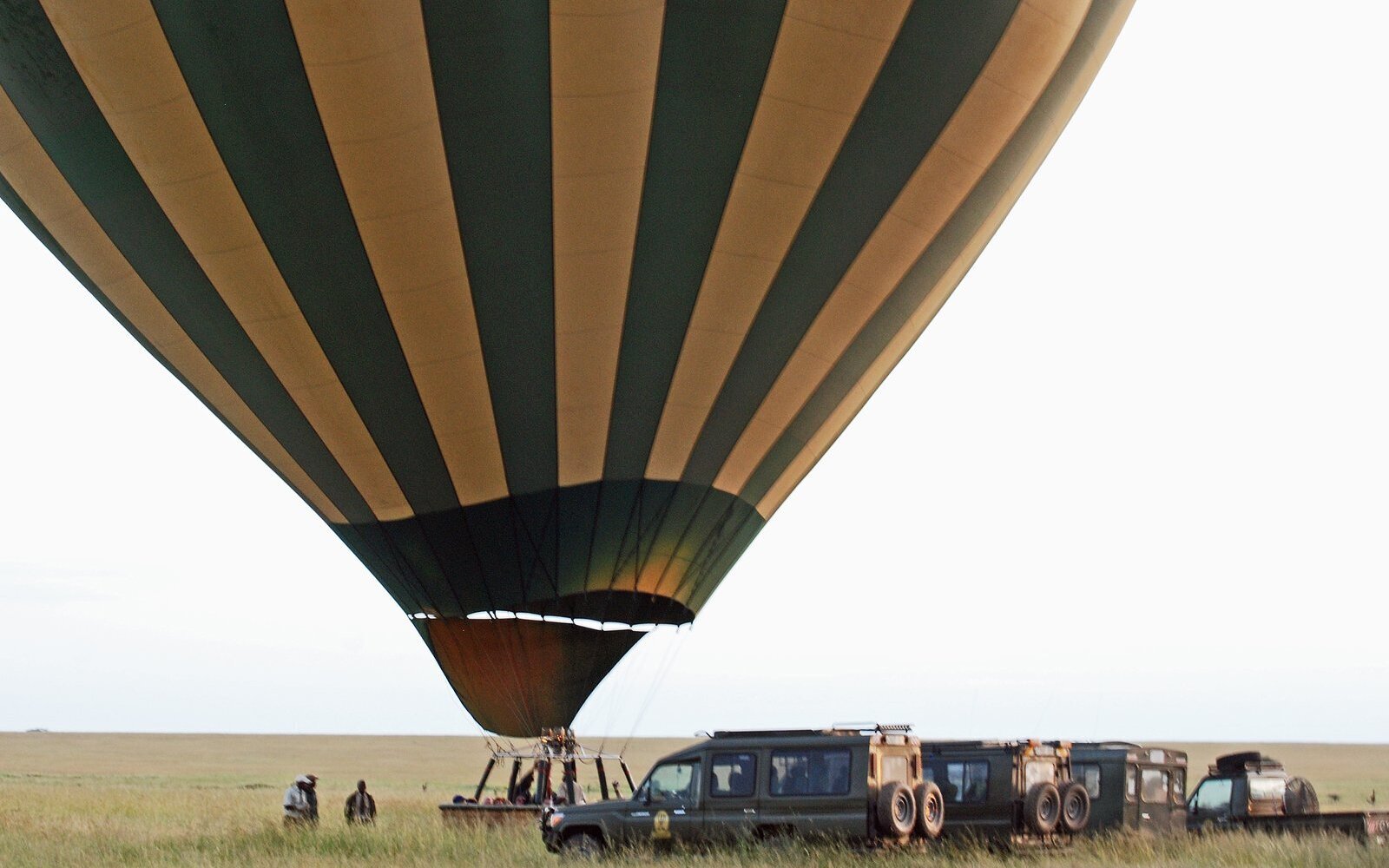 A hot-air balloon drifting over the African plains at sunrise