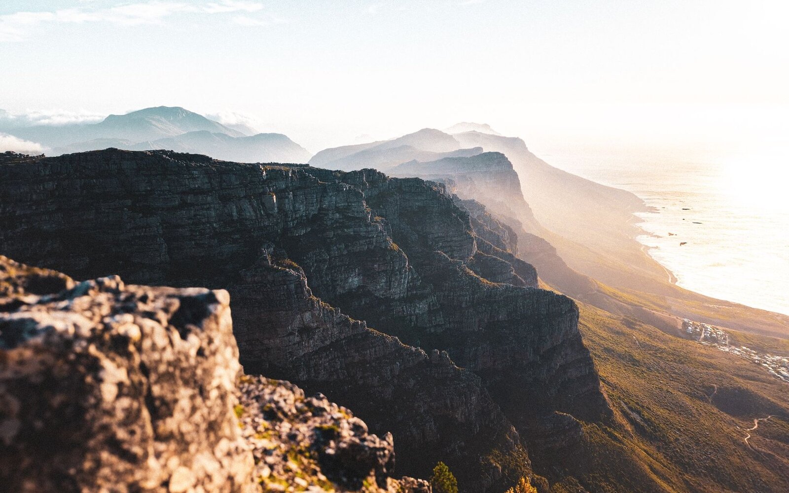 Table Mountain rising above Cape Town and the sea at golden hour