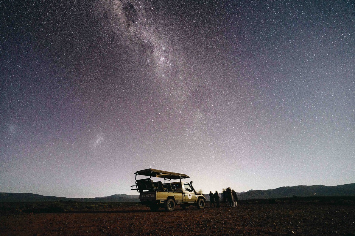 Milky Way over the Tankwa Karoo plains at Inverdoorn with a game vehicle in silhouette