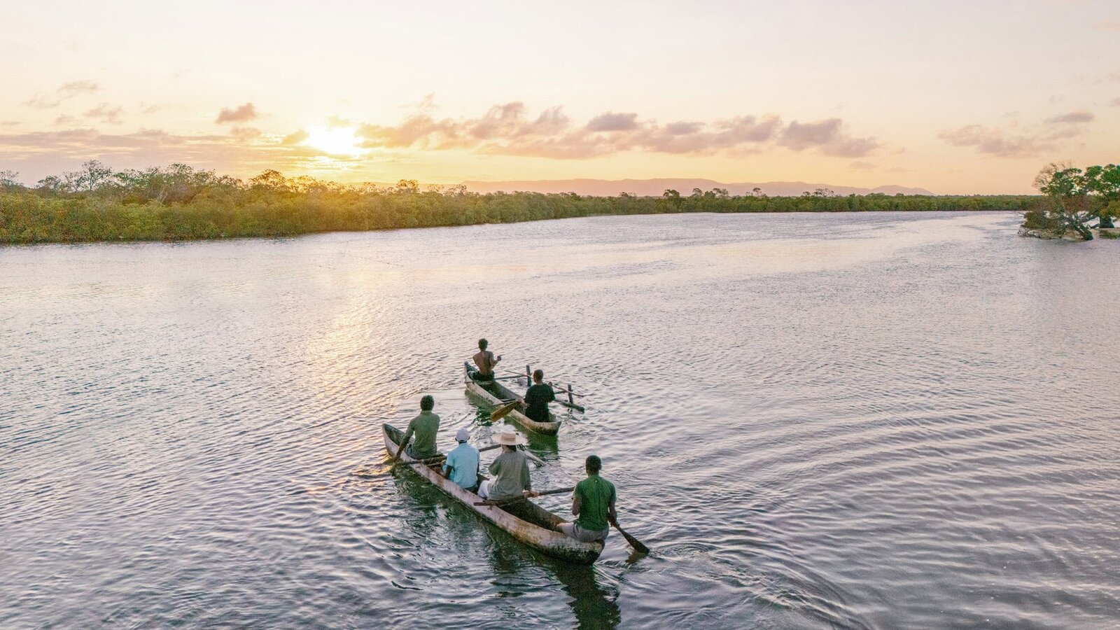 A traditional pirogue on calm water at sunset near Miavana, northern Madagascar