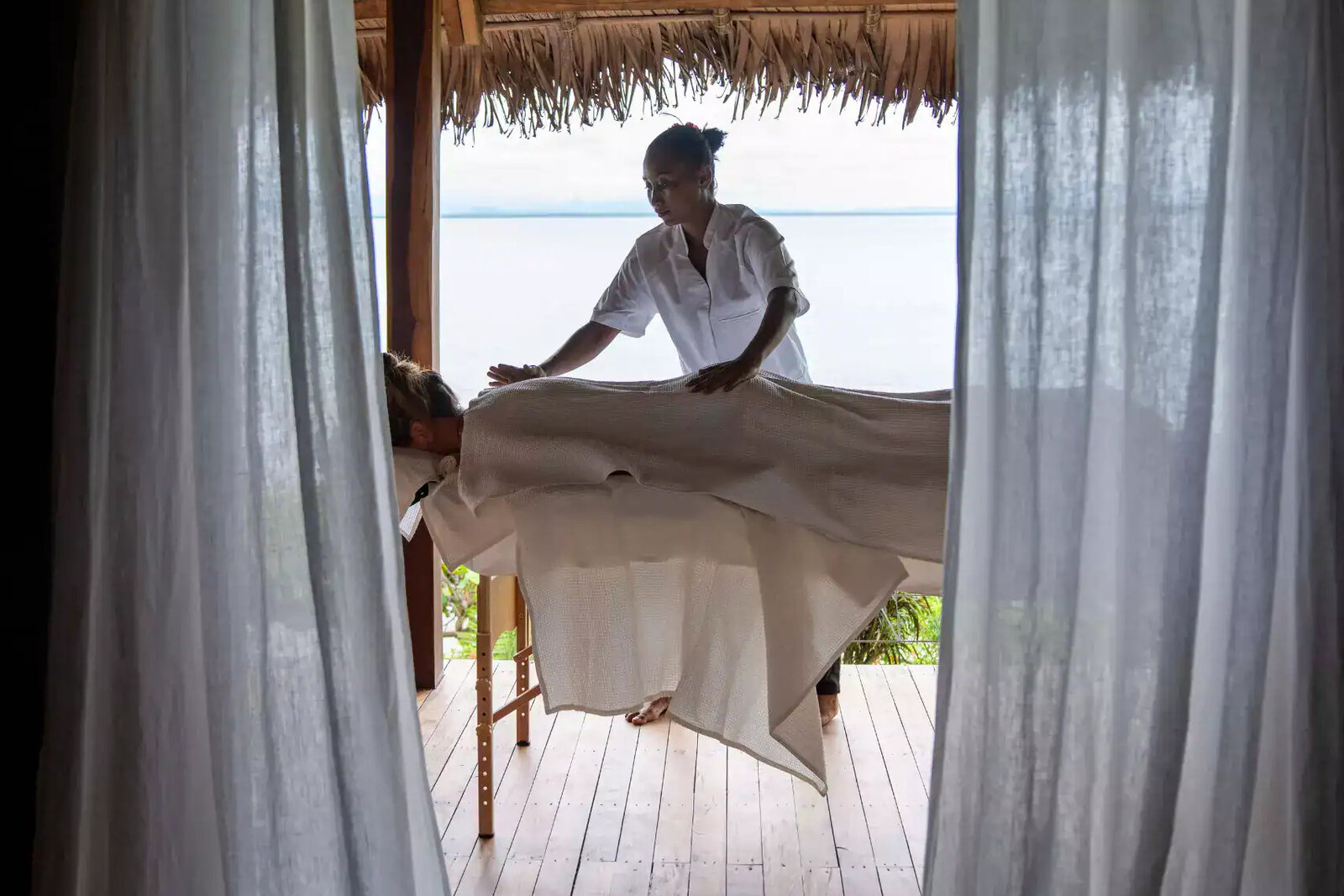 In-room wellness treatment on a private villa deck at Time + Tide Tsara Komba, Nosy Komba, Madagascar
