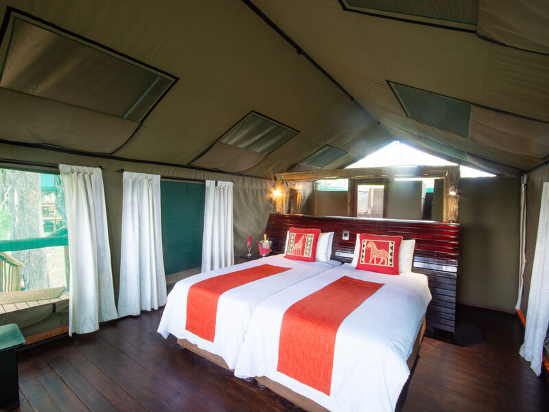 Spacious Meru-style tented suite interior at Moremi Crossing with en-suite comfort and quality linens