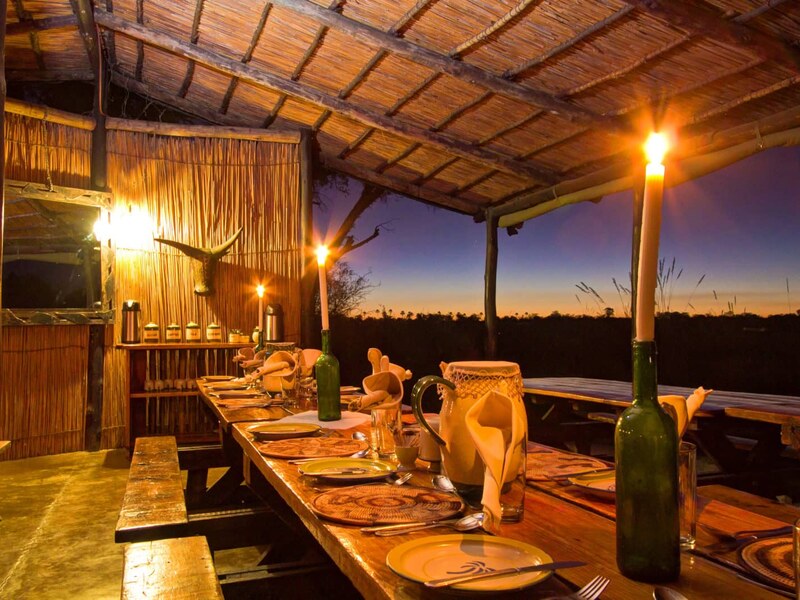 Candlelit outdoor dinner setup at Oddballs Camp under the Delta sky