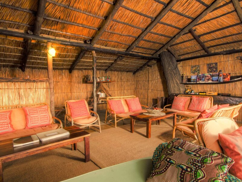 Thatched open-air lounge and bar area at Oddballs Camp overlooking the Boro Channel