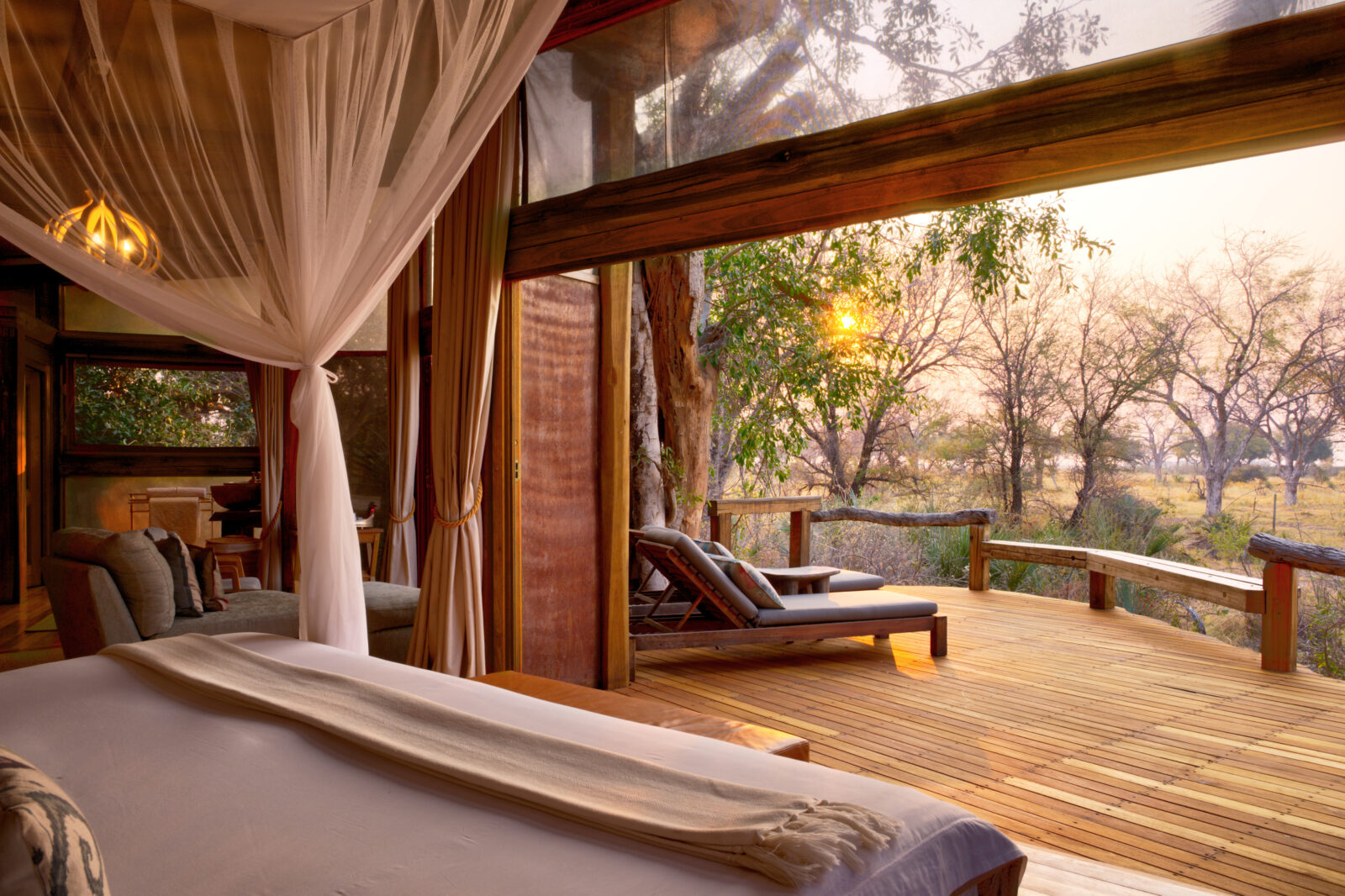 A spacious tented guest room with twin beds at Camp Okavango on Nxaragha Island