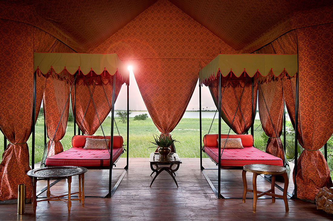 The opulent 1940s-style tented interior with hanging daybeds at Jack’s Camp, Makgadikgadi