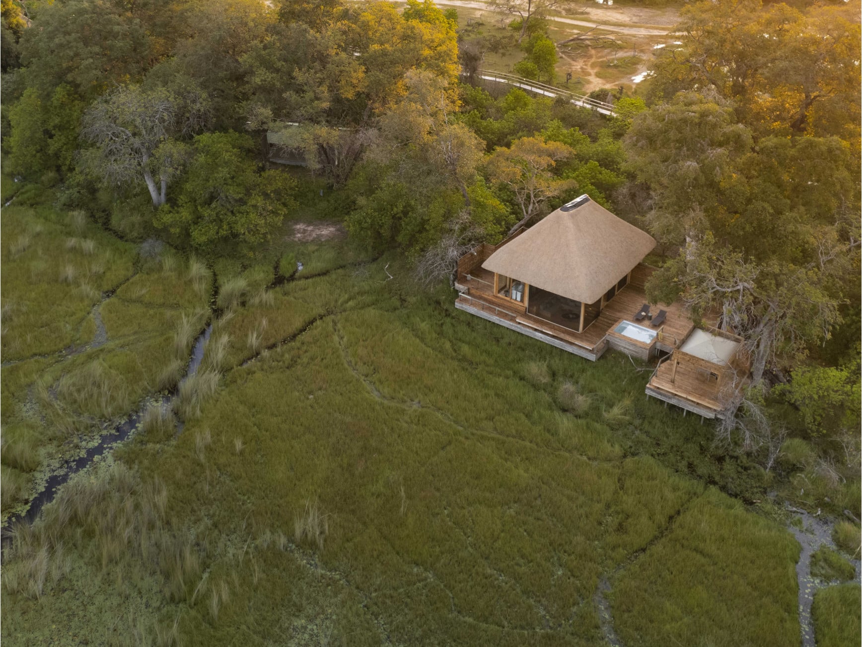 An aerial view of a Vumbura Plains suite and plunge pool amid the northern Okavango floodplain