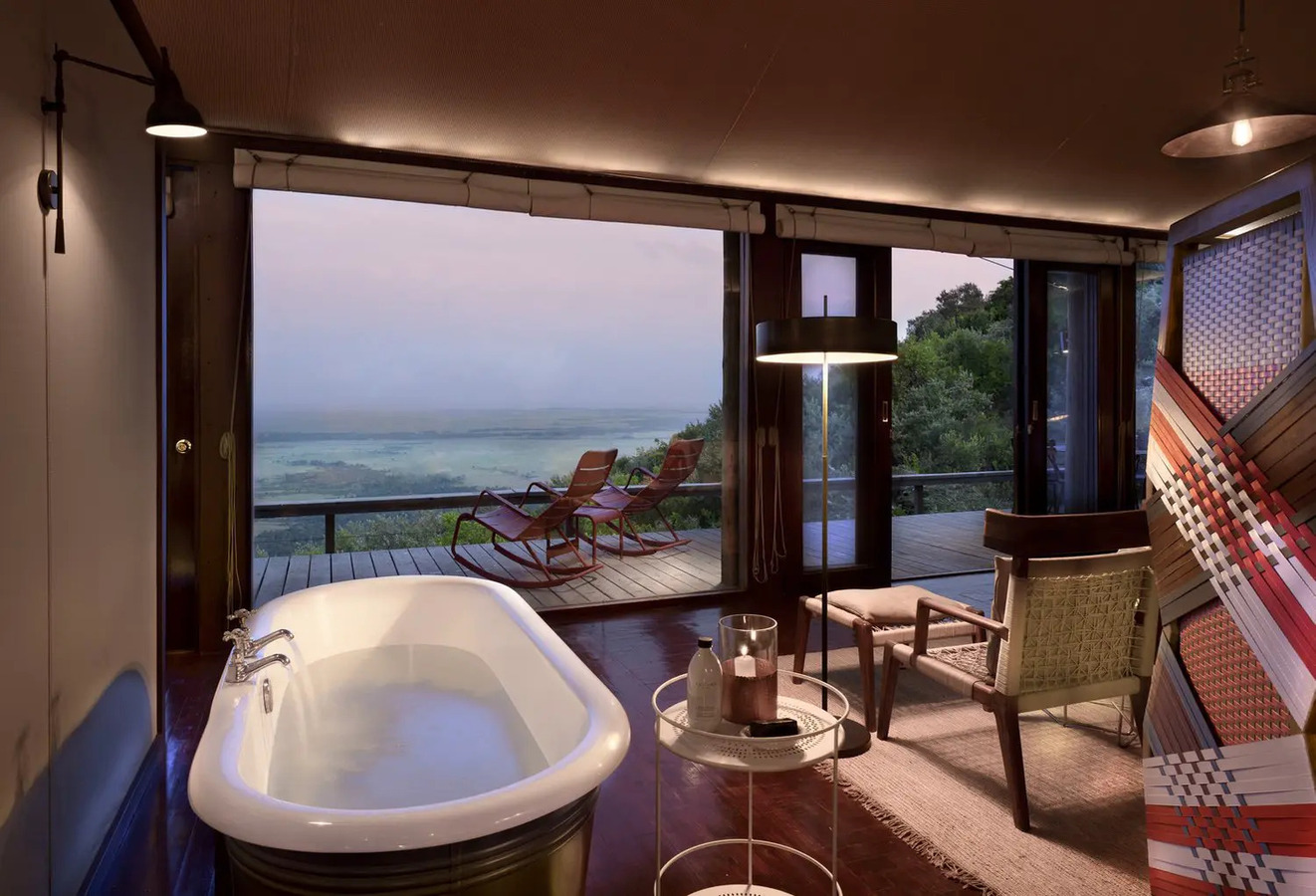 Angama Mara suite bathroom with copper freestanding bathtub and Mara views