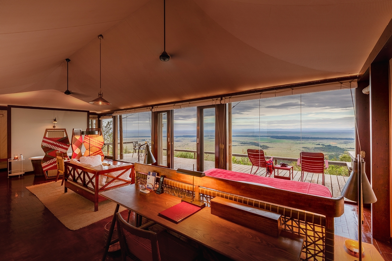 Angama Mara private suite deck with outdoor furniture overlooking the plains