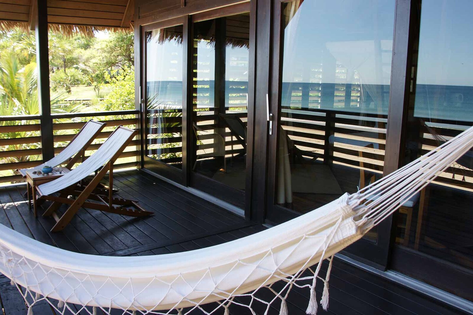 A rosewood villa deck with a hammock looking over the ocean at Anjajavy le Lodge, north-west Madagascar