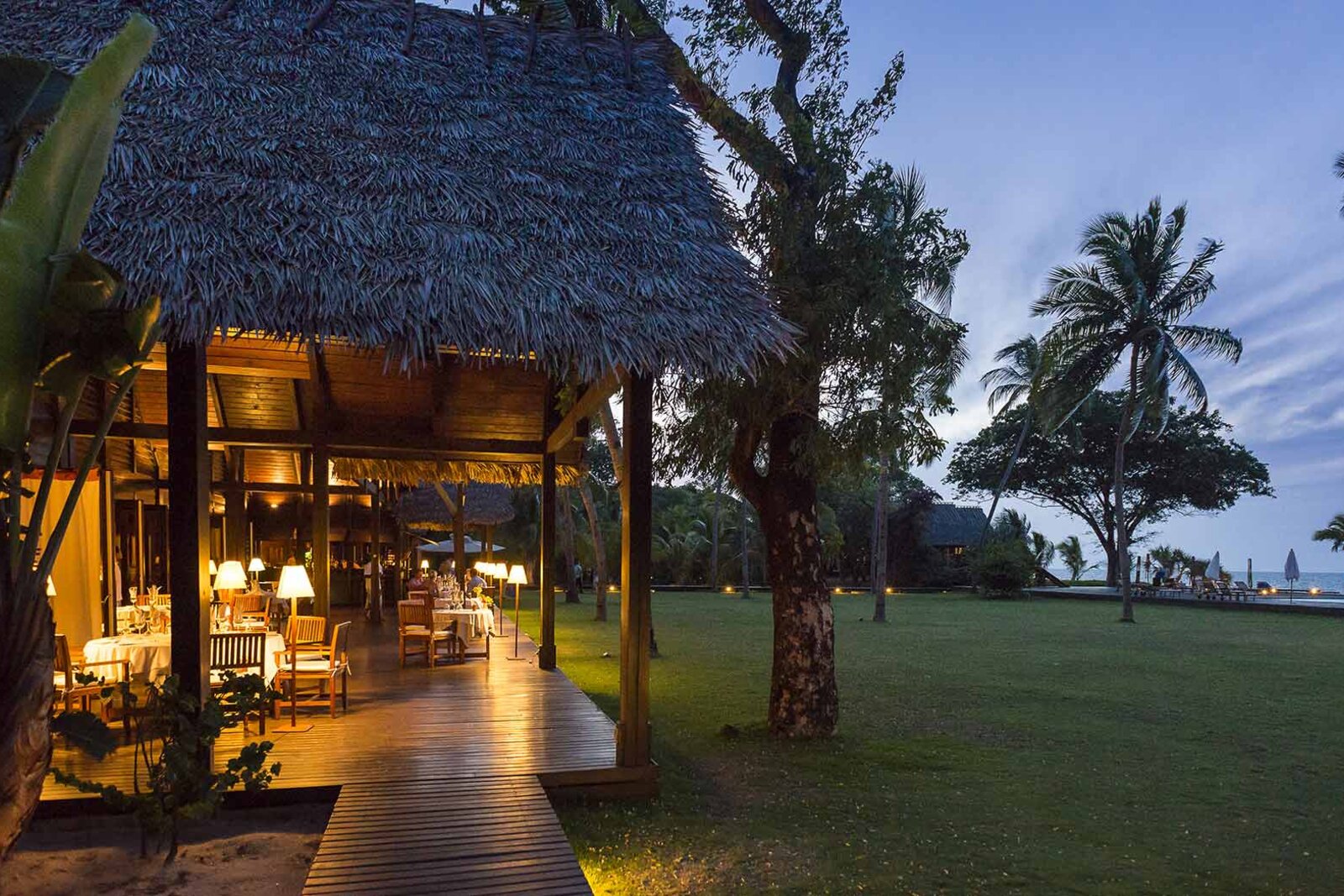 The great thatched lodge glowing at dusk at Anjajavy le Lodge, Madagascar