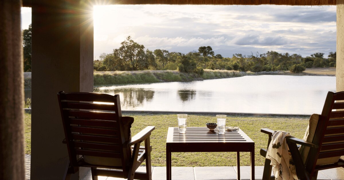 Private deck chairs on an Arathusa suite verandah looking over the waterhole in the Sabi Sand