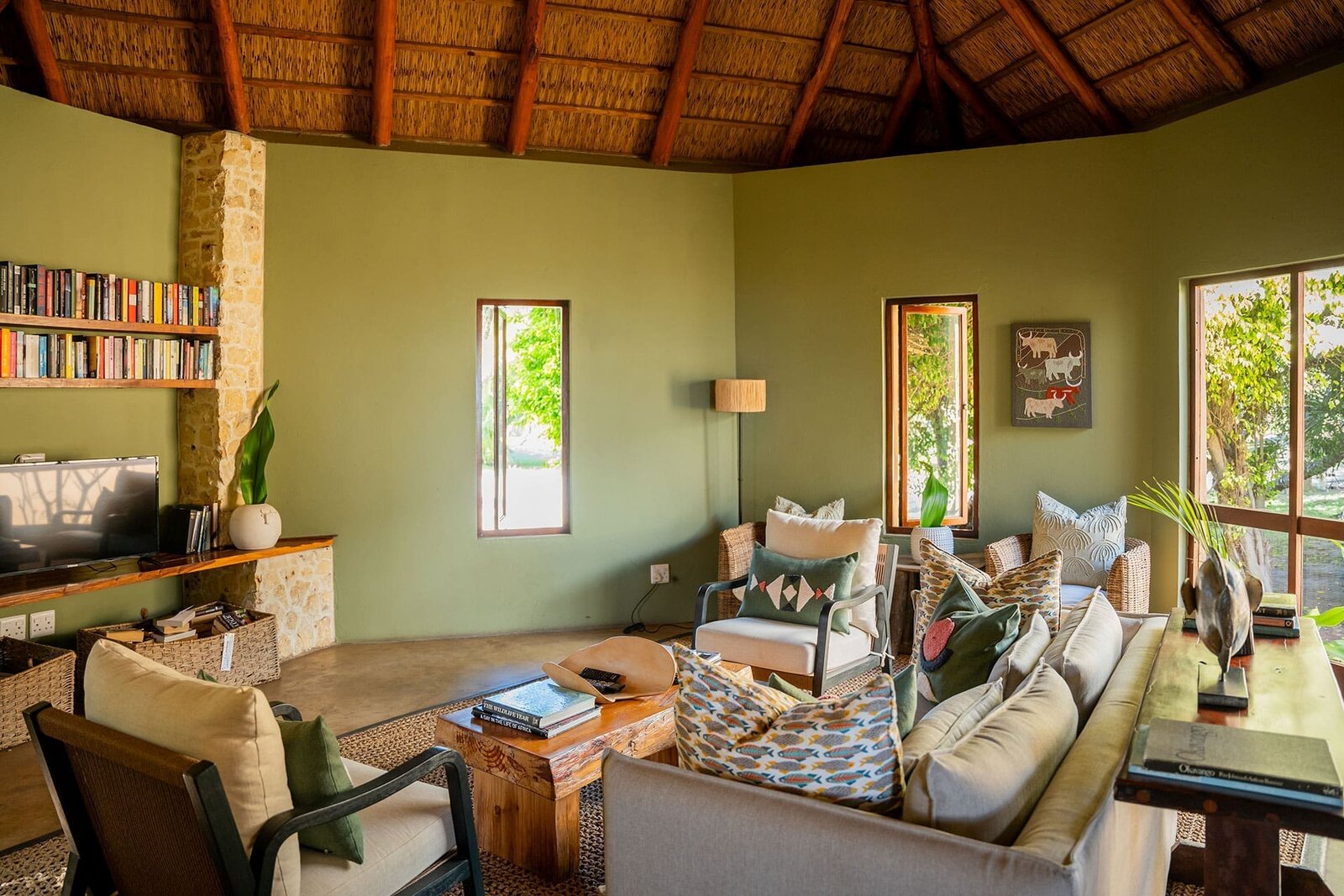A villa living area at Azura Benguerra with natural textures and glass doors opening to the sea, Mozambique