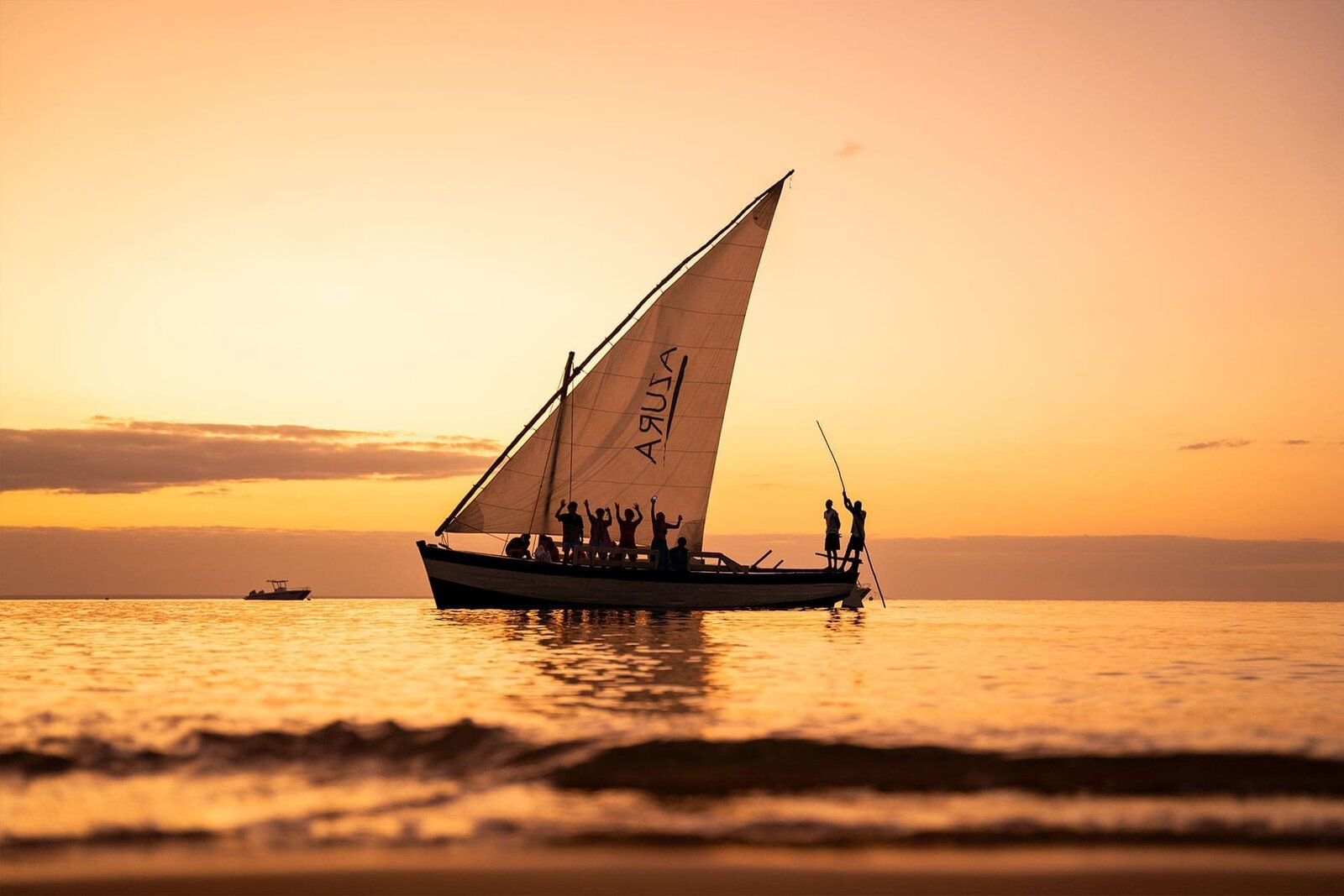 A dhow sailing at sunset off Benguerra Island at Azura, Bazaruto Archipelago, Mozambique