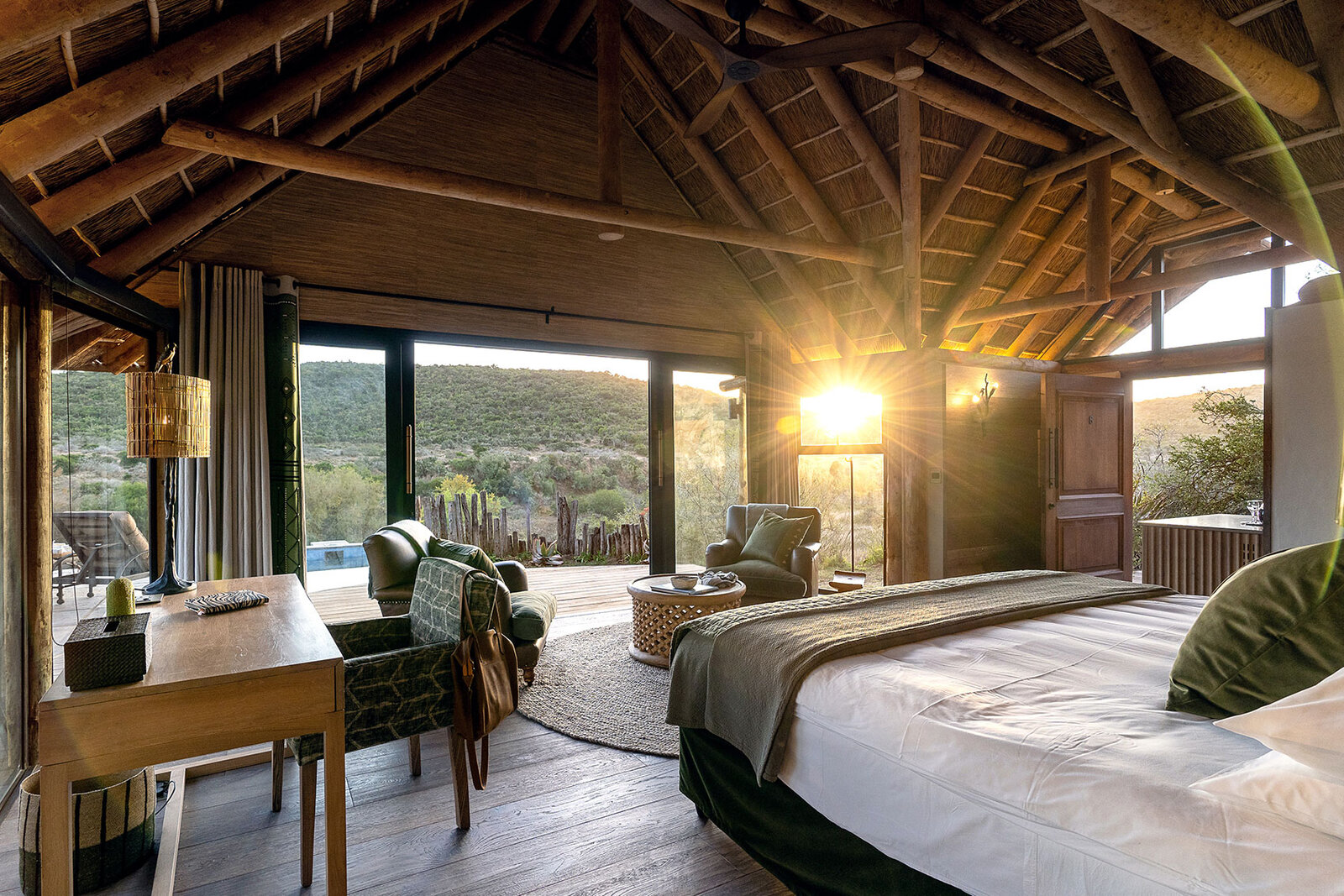 A Great Fish River Lodge suite at sunrise with river-gorge views at Kwandwe
