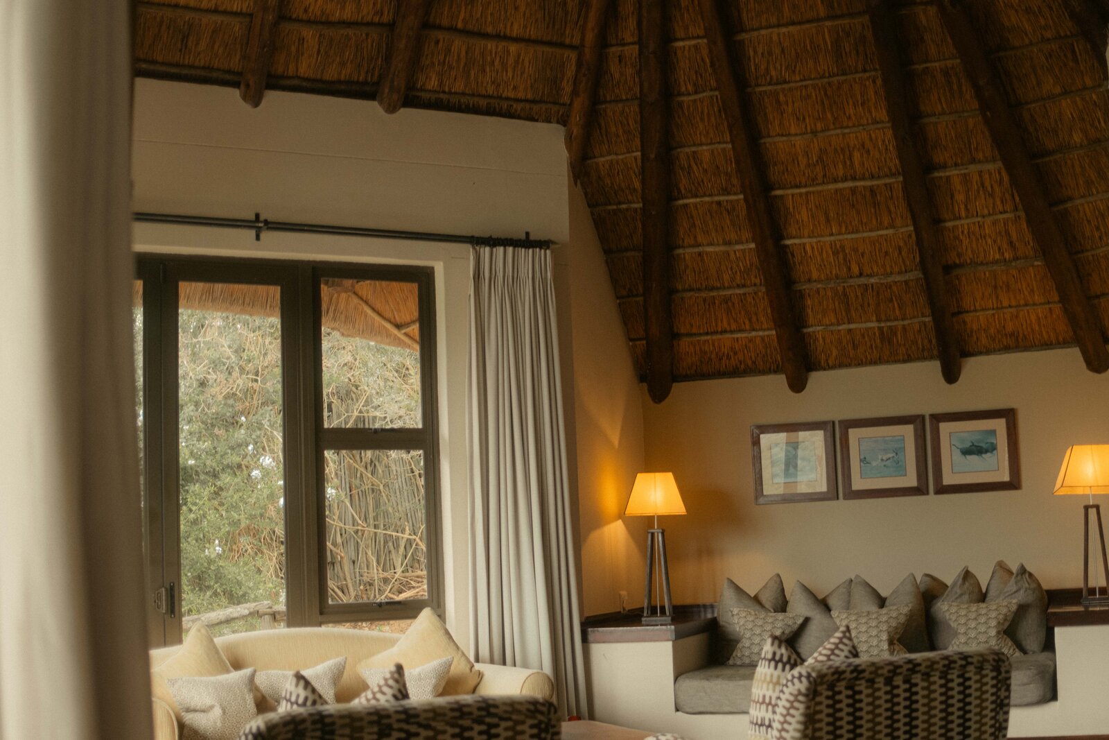 Stone-and-glass architecture at Pumba Water Lodge overlooking the lake