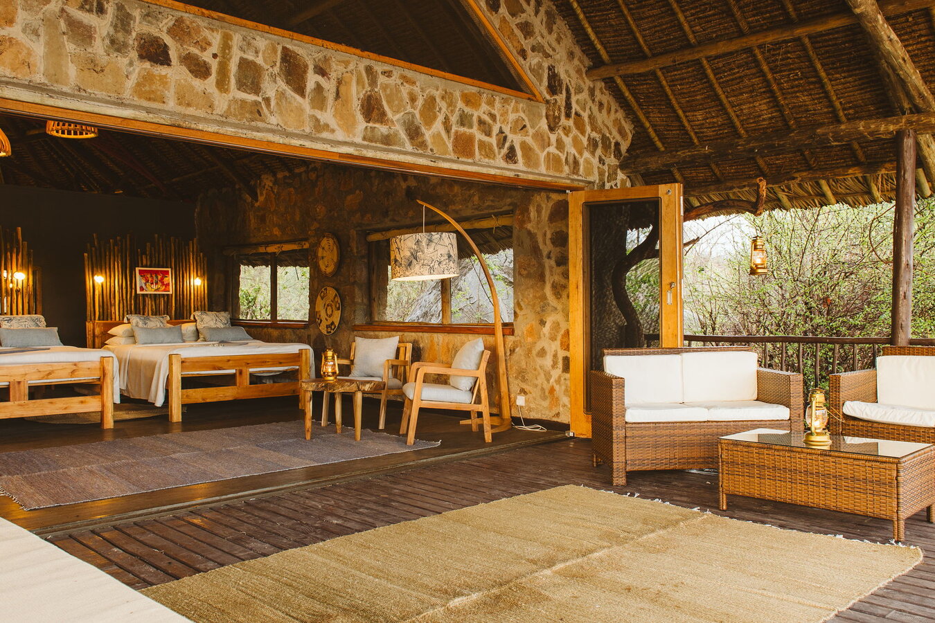 Ruaha River Lodge stone-and-thatch bandas overlooking the Great Ruaha River