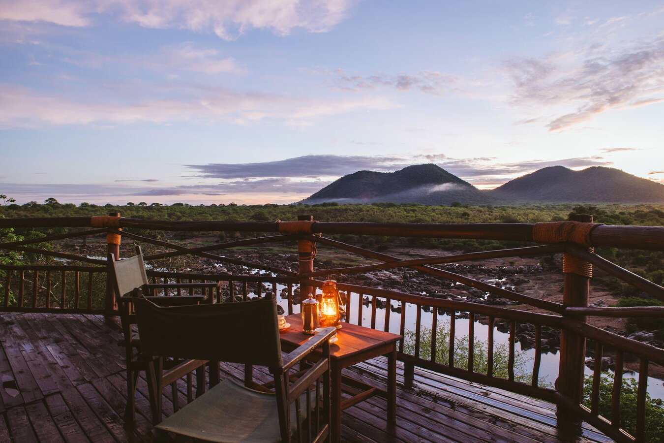 Ruaha River Lodge deck and dining area overlooking the Great Ruaha River at sunset