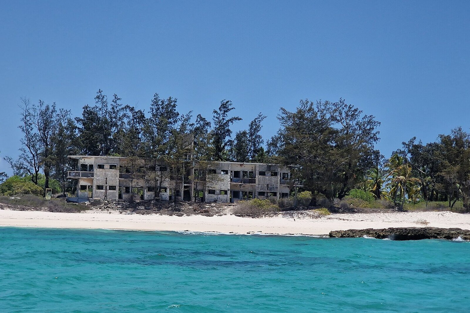 The ruins of the old hotel on Santa Carolina, Paradise Island, above a turquoise sea in Mozambique