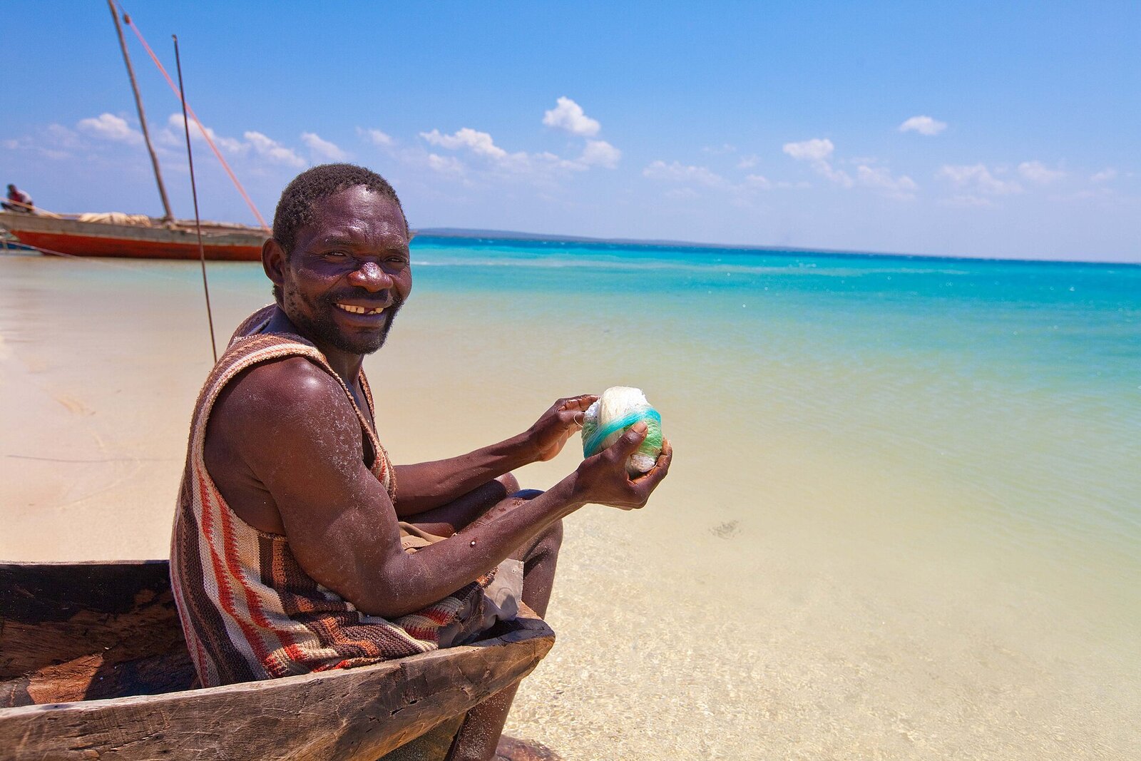 A local fisherman on a traditional dhow in the calm turquoise bay at Vilanculos, Mozambique