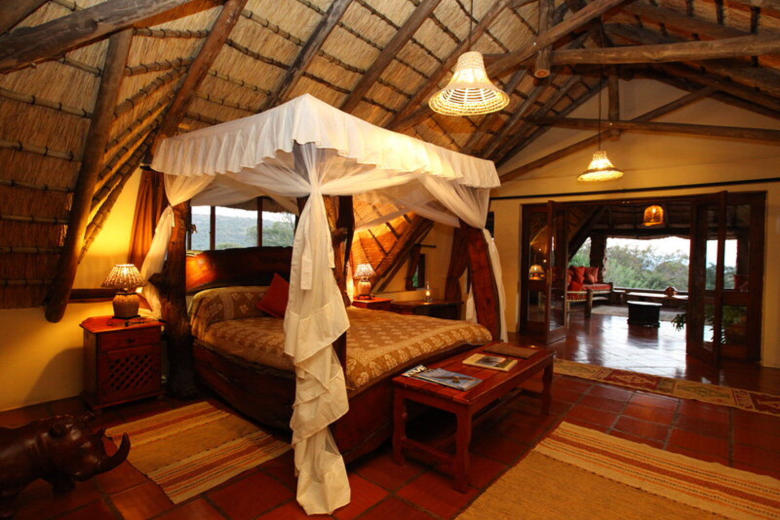 Luxury en-suite bedroom with four-poster bed at Ant's Hill bush home in the Waterberg