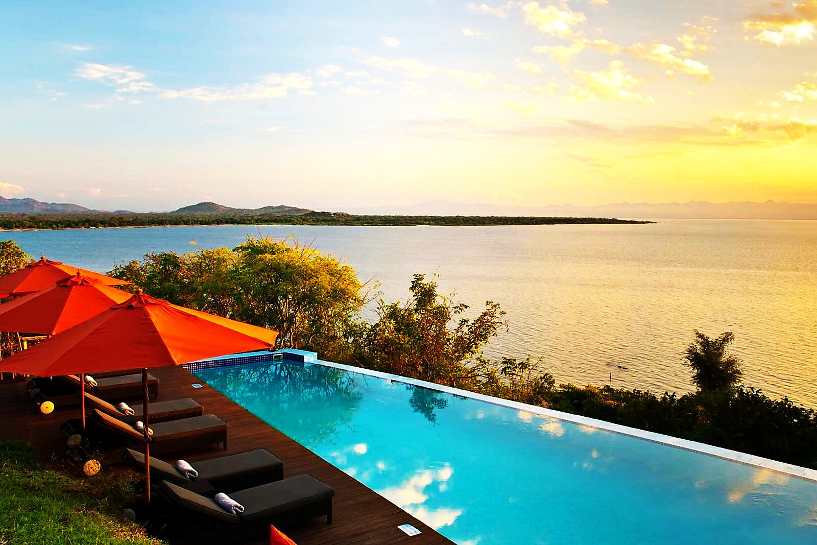 An infinity pool overlooking Lake Malawi at sunset