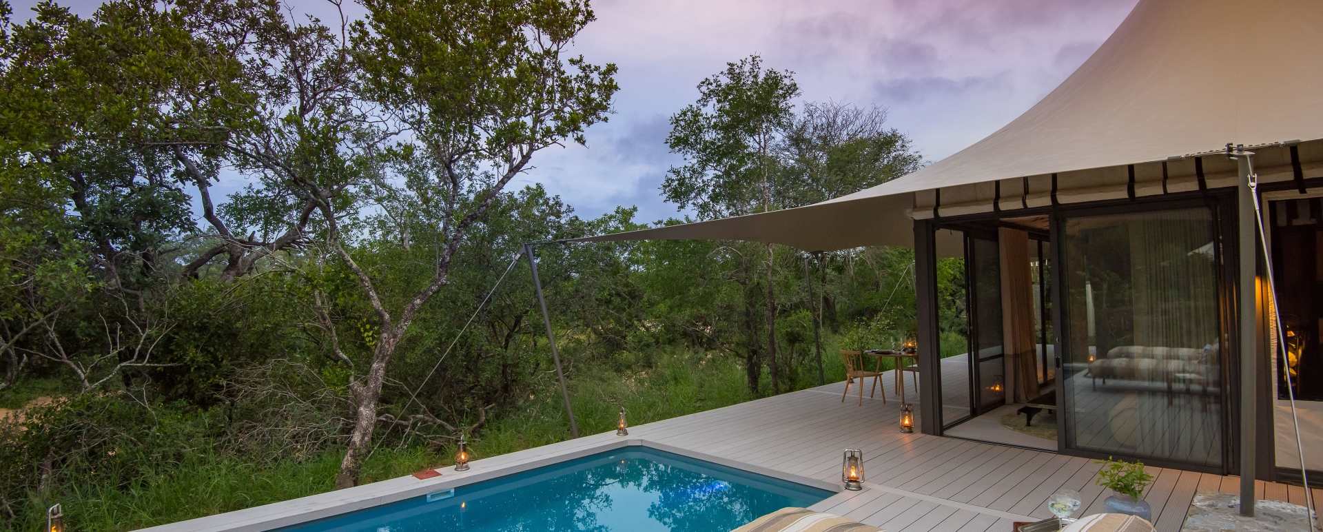 A private deck with plunge pool on a luxury tented suite overlooking the bushveld at sunset