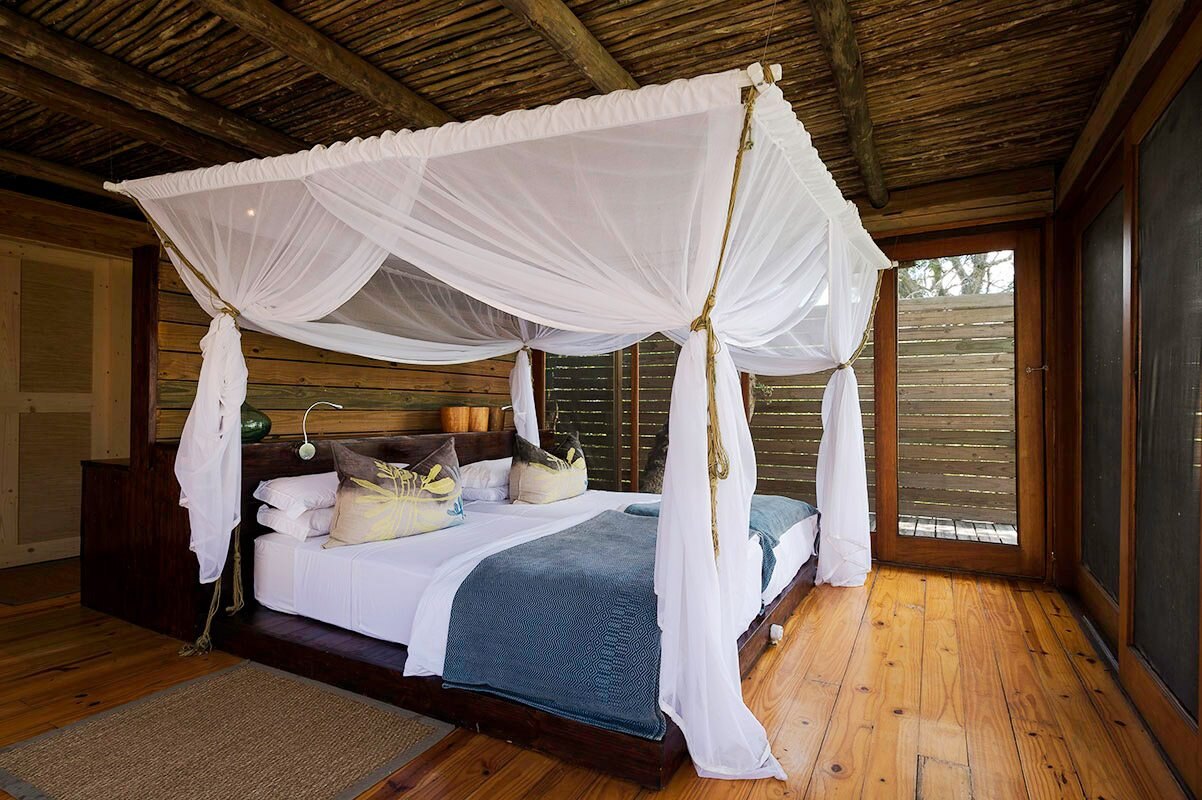 A contemporary canopy-bed suite at Vumbura Plains in the Okavango Delta