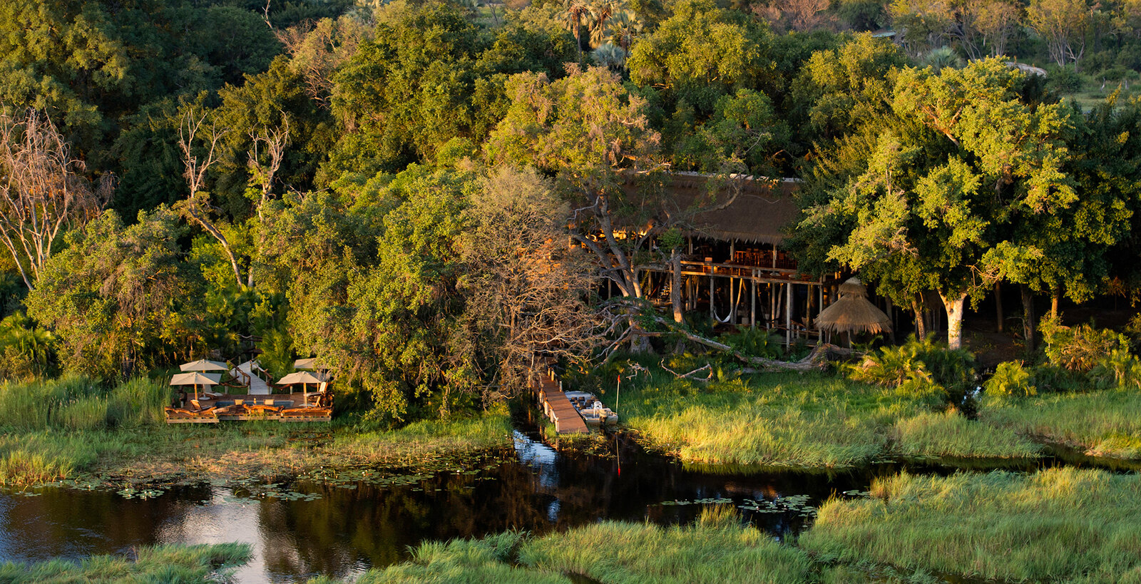 Aerial view of Jao Camp set among the trees of the Okavango Delta