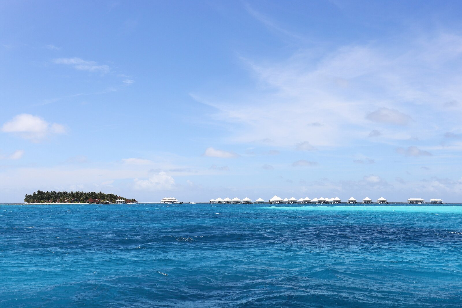 Overwater villas above a calm turquoise lagoon in the Maldives — the dry season, December to April, is the best time to visit