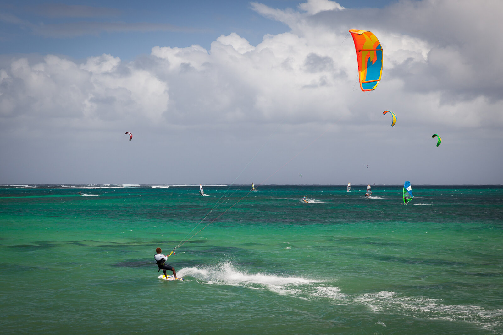 A kitesurfer riding the trade winds in the lagoon at Le Morne, Mauritius