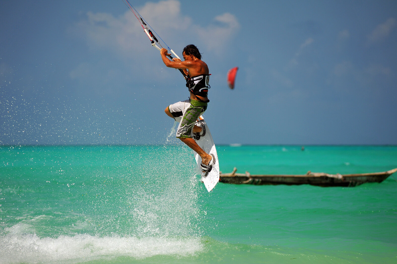 A kitesurfer riding the reef-flat lagoon at Paje, Zanzibar, on the steady Kusi trade wind
