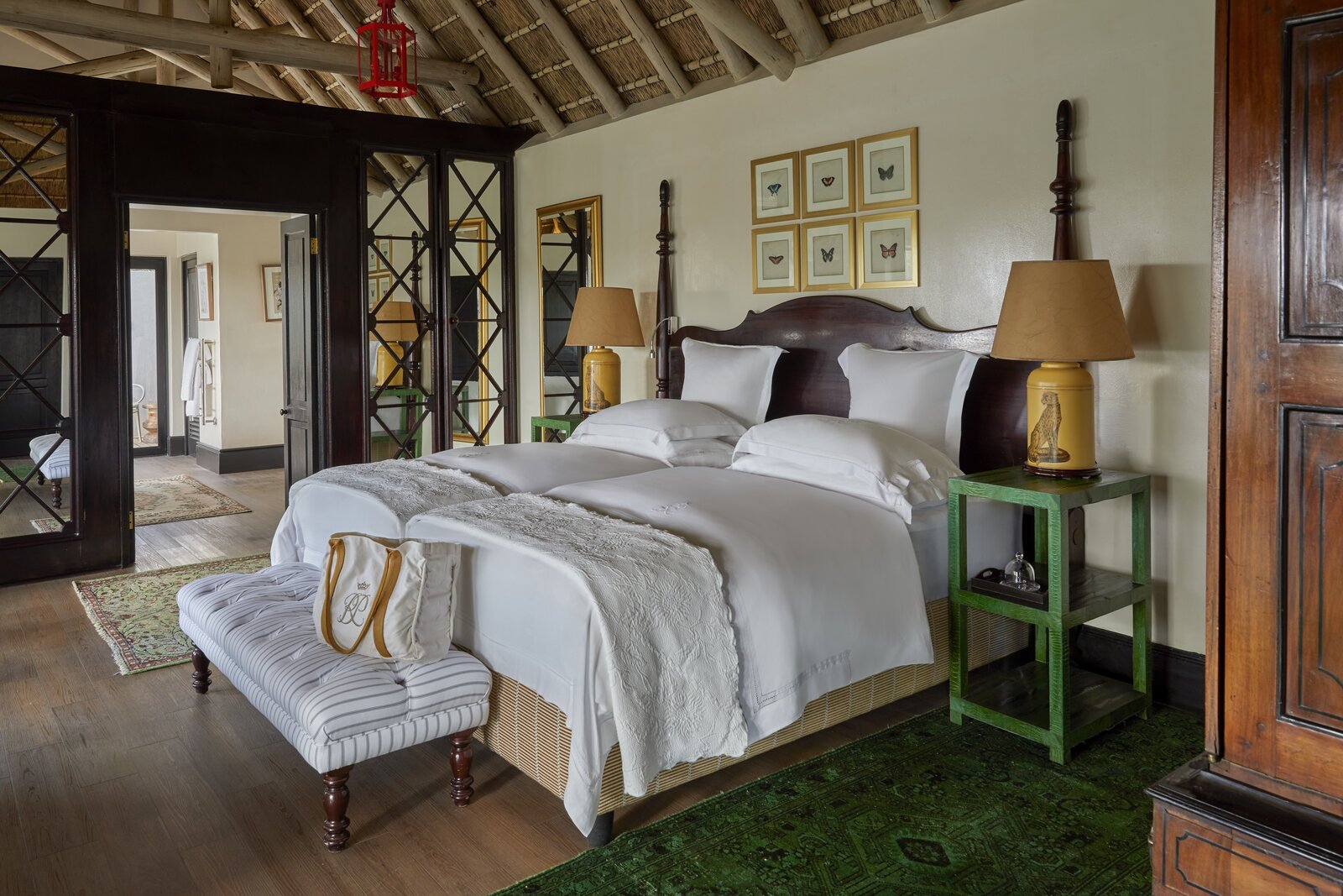 A grand suite bedroom open to the bush at a luxury safari lodge