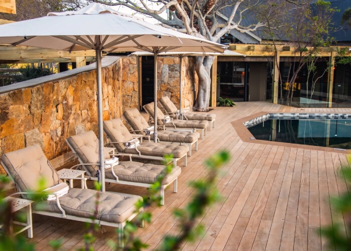 Botlierskop Tented Lodge pool deck with fynbos and mountain backdrop