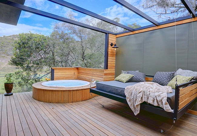 Private tented suite deck with outdoor jacuzzi overlooking the Botlierskop reserve