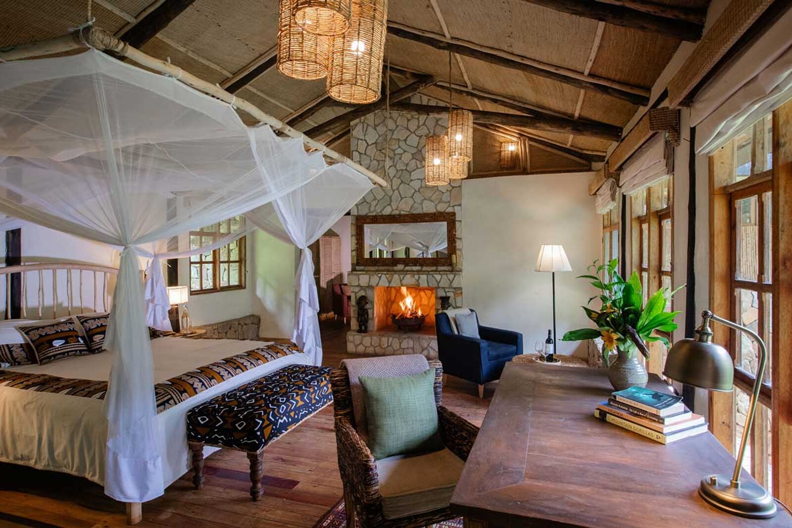 Bwindi Lodge deluxe room with four-poster bed overlooking the forest