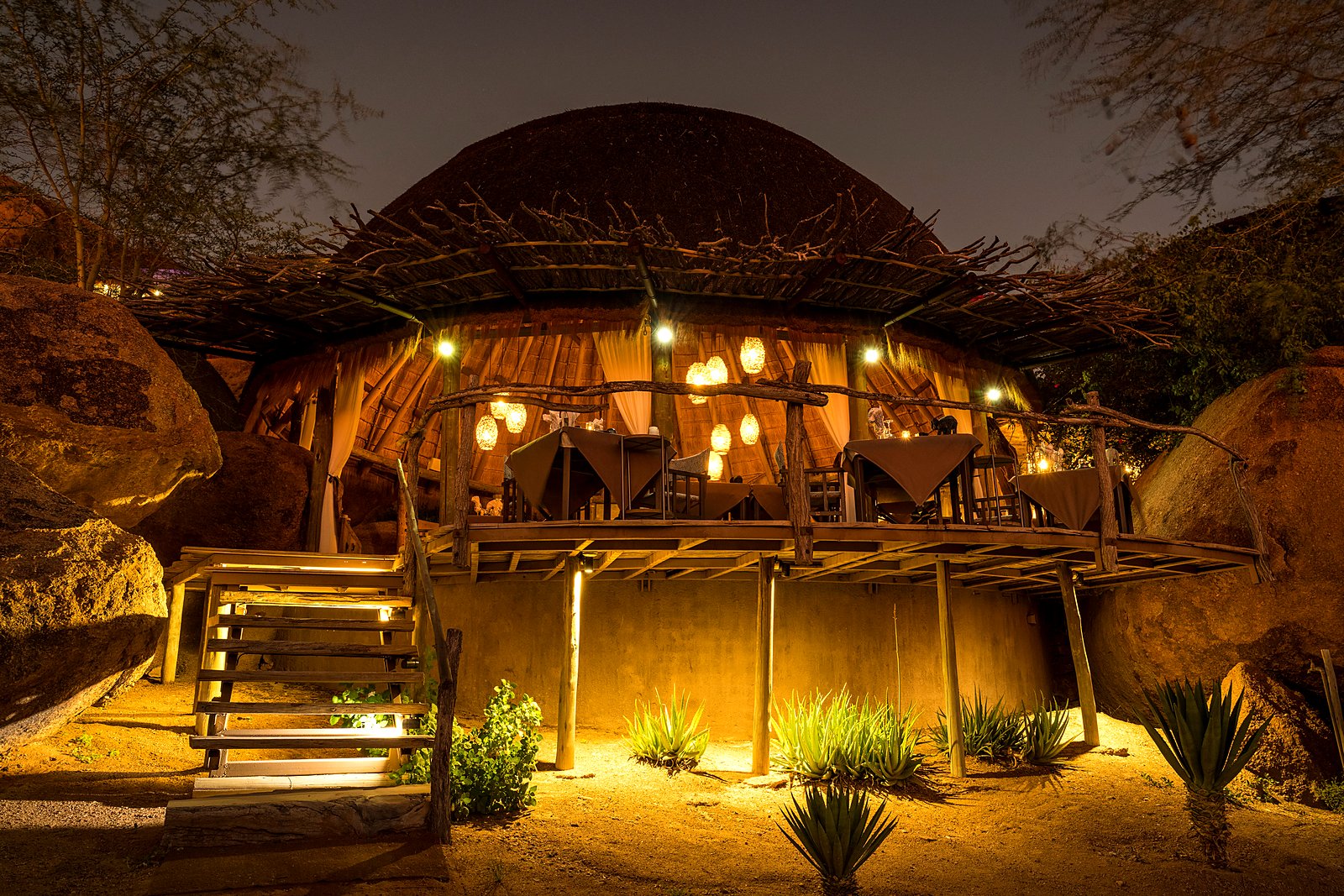 Open-air en-suite bathroom set into the boulders at Camp Kipwe