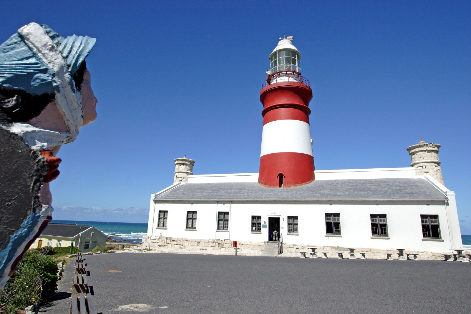 The Cape Agulhas Lighthouse standing on its low hill above the coast
